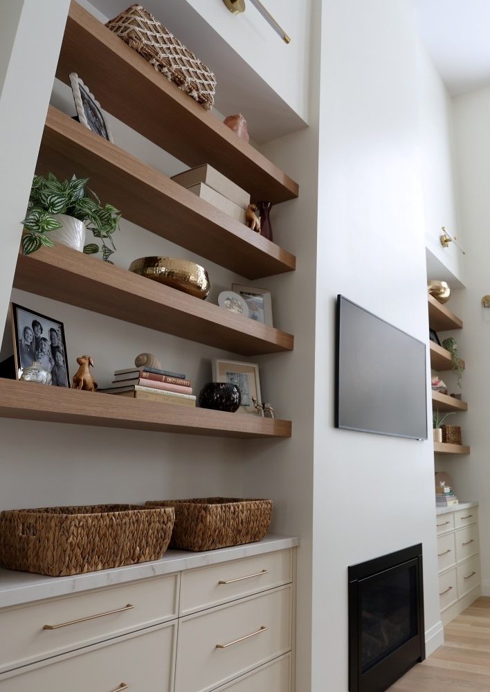 Specialty - in-wall shelves of natural wood and off-white cabinets