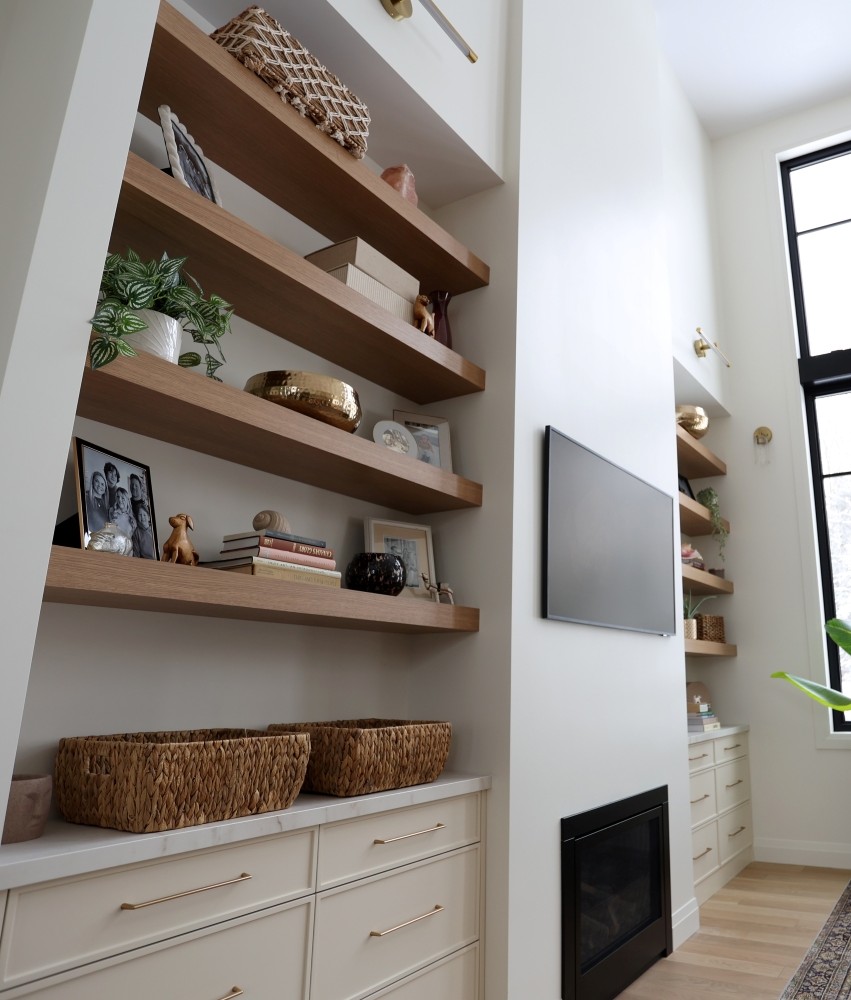Specialty - in-wall shelves of natural wood and off-white cabinets